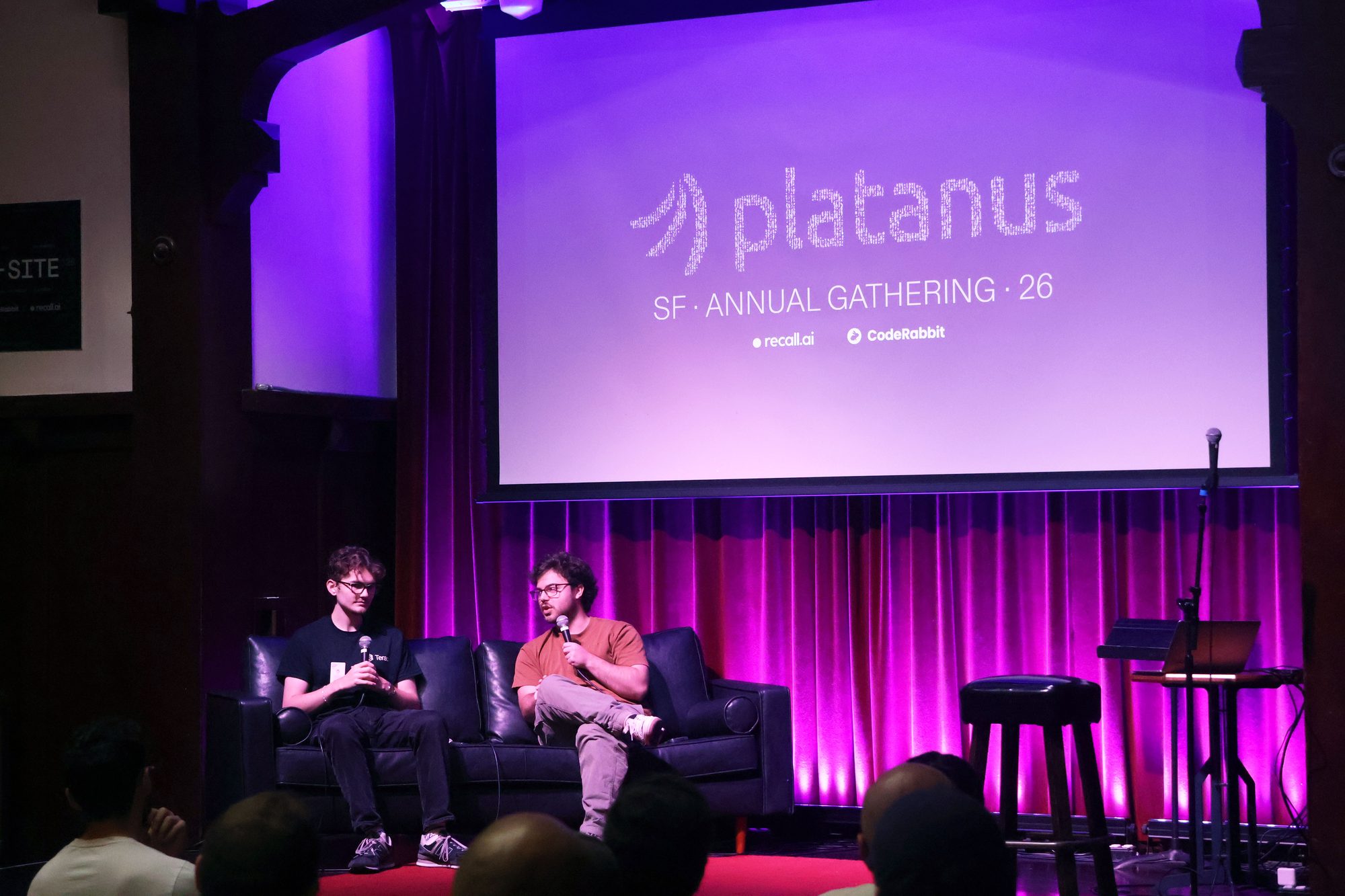 Fireside chat on the Swedish American Hall stage under a Platanus SF Annual Gathering 26 projection