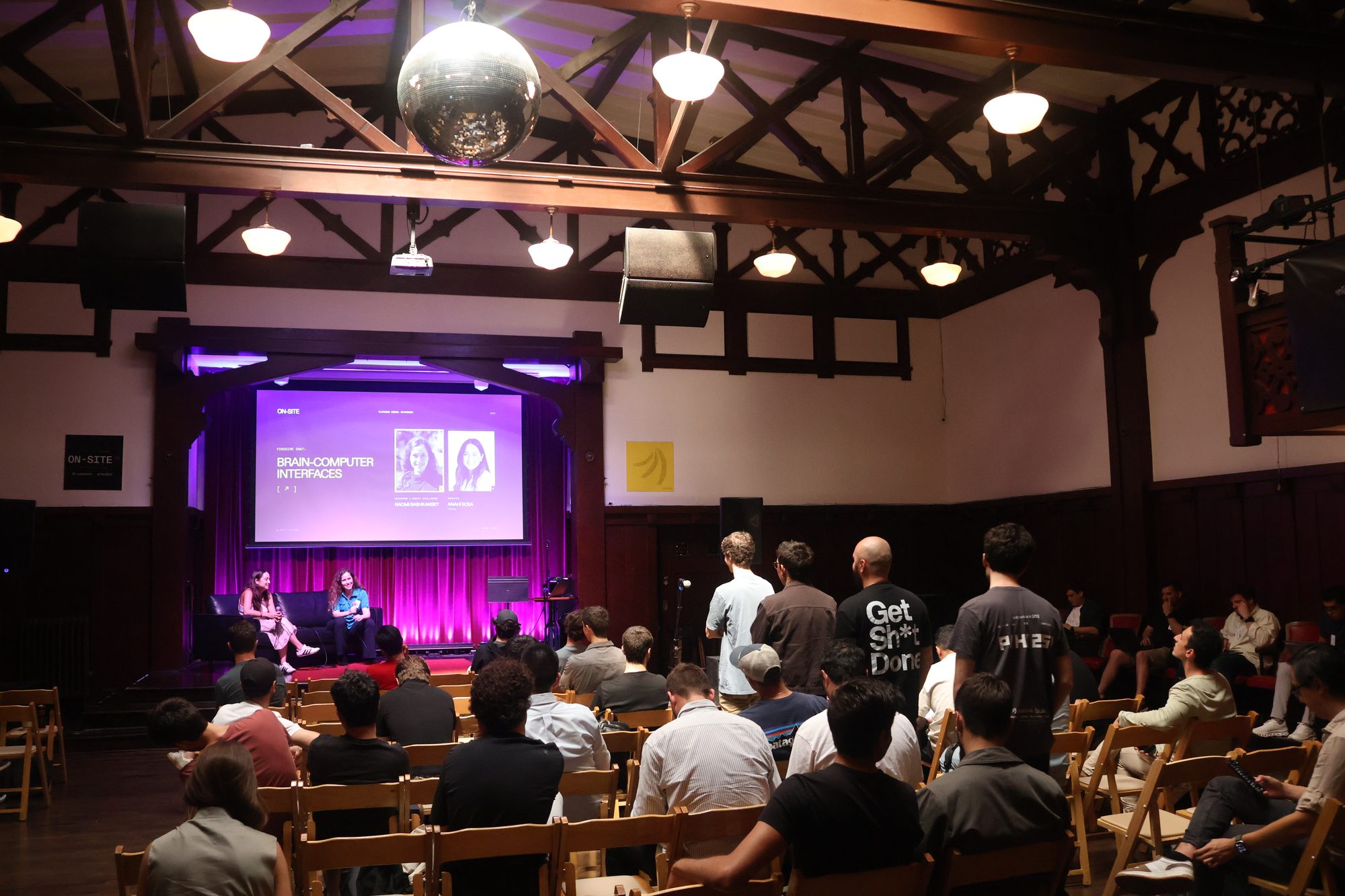 Brain-computer interfaces panel in Swedish American Hall with attendees lined up for audience Q&A