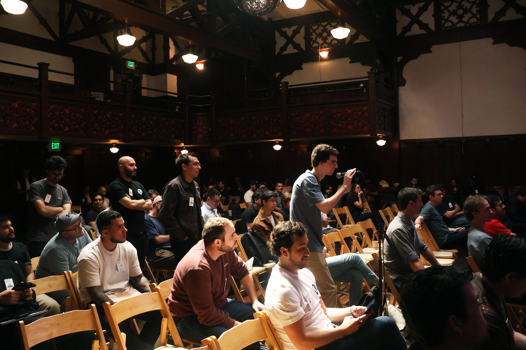 Founders asking questions at an audience microphone during a startup conference in San Francisco