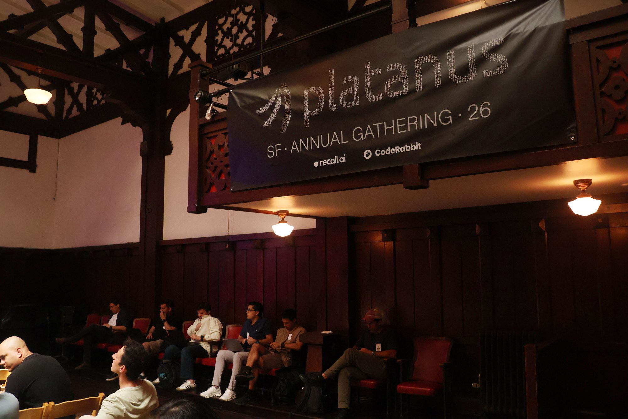 Platanus SF Annual Gathering banner hanging from the historic carved balcony at Swedish American Hall